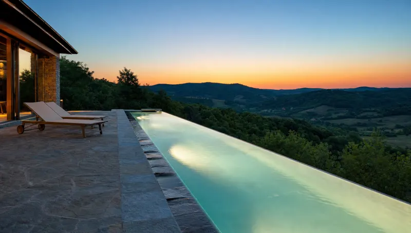 Infinity-edge pool looking over the hills at dusk